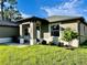 Inviting front entrance with well-kept landscaping and a freshly painted exterior, creating a welcoming appeal at 5473 Gagnon Ter, North Port, FL 34291