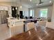 Open floor plan with kitchen, dining area, and living room, featuring stainless steel appliances and comfortable seating at 5473 Gagnon Ter, North Port, FL 34291