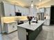 Modern kitchen showcasing white cabinetry, a large island with quartz countertops, and stainless steel appliances at 5473 Gagnon Ter, North Port, FL 34291