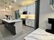 Lovely kitchen featuring white cabinets, modern appliances, a center island, and an open layout at 5473 Gagnon Ter, North Port, FL 34291