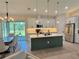 Spacious kitchen and dining area with white cabinets, stainless steel appliances, and a large island at 5473 Gagnon Ter, North Port, FL 34291