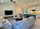 Open-concept living space featuring modern furnishings, sleek lighting fixtures, and seamless flow to the dining area at 5473 Gagnon Ter, North Port, FL 34291
