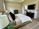 Well-lit main bedroom featuring tray ceilings, a neutral color palette, and an ensuite bathroom at 5473 Gagnon Ter, North Port, FL 34291