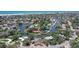 Aerial view of a picturesque waterfront neighborhood surrounded by tropical trees and convenient access to beaches at 5502 Shadow Lawn Dr, Sarasota, FL 34242