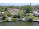 A waterfront property with a dock and lush landscaping, perfect for relaxation at 5502 Shadow Lawn Dr, Sarasota, FL 34242