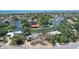Waterfront property with ample yard space, mature landscaping, and convenient street access at 5502 Shadow Lawn Dr, Sarasota, FL 34242