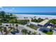 Aerial view of Siesta Beach showing the beach access, parking, volleyball courts, and white sandy beach at 5502 Shadow Lawn Dr, Sarasota, FL 34242