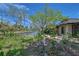 Backyard view featuring lush landscaping and peaceful waterfront canal access at 5502 Shadow Lawn Dr, Sarasota, FL 34242