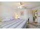 Bright bedroom with a queen-size bed, ceiling fan and open doorway at 5624 Ashton Lake Dr # 5624, Sarasota, FL 34231