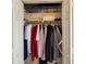 A bright closet with clothes hanging on a metal rod and shirts stacked on a white wire rack above at 5624 Ashton Lake Dr # 5624, Sarasota, FL 34231