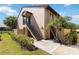 Exterior view of condo with stairs, landscaping, and palm trees at 5624 Ashton Lake Dr # 5624, Sarasota, FL 34231