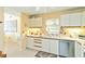 Bright kitchen with white cabinets, stainless steel dishwasher and tile backsplash at 5624 Ashton Lake Dr # 5624, Sarasota, FL 34231