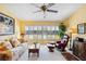 Comfortable living room with a ceiling fan and large windows that have white shutters at 5624 Ashton Lake Dr # 5624, Sarasota, FL 34231