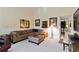 Open living room with a comfortable sectional sofa, ottoman, and neutral decor at 5624 Ashton Lake Dr # 5624, Sarasota, FL 34231