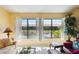 Bright living room featuring large windows with white shutters and lovely water views at 5624 Ashton Lake Dr # 5624, Sarasota, FL 34231