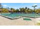 Community pool surrounded by palm trees and lounge chairs, providing a refreshing and social space at 5624 Ashton Lake Dr # 5624, Sarasota, FL 34231