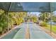 Community shuffleboard court surrounded by lush greenery and landscaping at 5624 Ashton Lake Dr # 5624, Sarasota, FL 34231