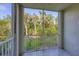Screened balcony with views of lush greenery and a serene outdoor setting at 5691 Bentgrass Dr # 15-101, Sarasota, FL 34235