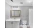 Bathroom features a modern vanity with a framed mirror, lighting fixture, toilet, and a shower at 5691 Bentgrass Dr # 15-101, Sarasota, FL 34235