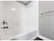 Bathroom featuring a white shower-tub combo with modern fixtures and accessories at 5691 Bentgrass Dr # 15-101, Sarasota, FL 34235