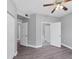 Bedroom boasts hard surface floors, a ceiling fan, and an open doorway to a bathroom at 5691 Bentgrass Dr # 15-101, Sarasota, FL 34235