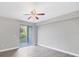Bedroom with a ceiling fan, sliding door to a balcony, and hard surface flooring at 5691 Bentgrass Dr # 15-101, Sarasota, FL 34235