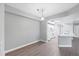 Well-lit dining area flows into the kitchen, featuring hard surface floors and a modern hanging light at 5691 Bentgrass Dr # 15-101, Sarasota, FL 34235