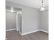 Neutral-toned hallway with hard surface floors and white baseboards provides access to rooms at 5691 Bentgrass Dr # 15-101, Sarasota, FL 34235