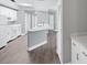 Large, open kitchen featuring white cabinets, hardwood flooring, and modern countertops at 5691 Bentgrass Dr # 15-101, Sarasota, FL 34235