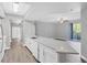 Bright open kitchen featuring white cabinets, modern appliances, and a long island bar at 5691 Bentgrass Dr # 15-101, Sarasota, FL 34235