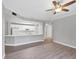 Open floor plan featuring a white kitchen and gray walls and hardwood flooring at 5691 Bentgrass Dr # 15-101, Sarasota, FL 34235