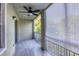 This screened-in patio has a ceiling fan and overlooks mature landscaping at 5691 Bentgrass Dr # 15-101, Sarasota, FL 34235