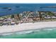 Stunning aerial view of a waterfront property with private dock and serene beach access to turquoise water at 581 Kingfisher Ln, Longboat Key, FL 34228