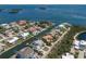 Waterfront homes with private docks line a canal in this aerial view, boasting luxury living and boat access at 581 Kingfisher Ln, Longboat Key, FL 34228