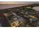 Stunning aerial view of waterfront homes along a canal near the ocean at sunset at 581 Kingfisher Ln, Longboat Key, FL 34228