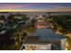 Stunning aerial view of waterfront properties on a peaceful canal at sunset at 581 Kingfisher Ln, Longboat Key, FL 34228