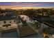 Sunset aerial view of neighborhood on canal featuring roof top deck at 581 Kingfisher Ln, Longboat Key, FL 34228