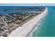 Stunning aerial view of the coastal community and the ocean at 581 Kingfisher Ln, Longboat Key, FL 34228