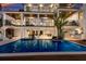 A luxury home featuring a pristine pool with a built-in spa, an outdoor kitchen, and an open-air living space at 581 Kingfisher Ln, Longboat Key, FL 34228