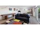 Finished basement with a sofa, shuffleboard table, pinball machine, and modern decor, offering versatile space at 581 Kingfisher Ln, Longboat Key, FL 34228