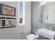 Modern bathroom with a vessel sink, gray tiled walls, and artwork creating an inviting space at 581 Kingfisher Ln, Longboat Key, FL 34228