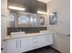Modern bathroom with dual sinks and a large mirror at 581 Kingfisher Ln, Longboat Key, FL 34228