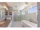 Well-lit bathroom with a soaking tub, a chandelier, and a glass-enclosed shower at 581 Kingfisher Ln, Longboat Key, FL 34228