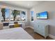 Bright bedroom features a workspace, large window, and light wood floors at 581 Kingfisher Ln, Longboat Key, FL 34228
