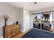 Bedroom with a sliding glass door leading to a deck and outdoor seating area at 581 Kingfisher Ln, Longboat Key, FL 34228
