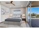 Bright bedroom features a ceiling fan, stylish rug, and sliding glass doors to an outdoor deck with a scenic view at 581 Kingfisher Ln, Longboat Key, FL 34228