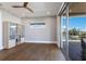 A well-lit room with a hardwood floor and sliding glass door that leads to a private deck at 581 Kingfisher Ln, Longboat Key, FL 34228