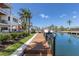 Waterfront property featuring a private boat dock and lush landscaping at 581 Kingfisher Ln, Longboat Key, FL 34228