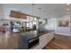 Open concept kitchen and living area featuring an island with a sink and dishwasher at 581 Kingfisher Ln, Longboat Key, FL 34228