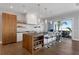 Modern kitchen featuring a large island with seating, white cabinetry, and stainless steel appliances at 581 Kingfisher Ln, Longboat Key, FL 34228